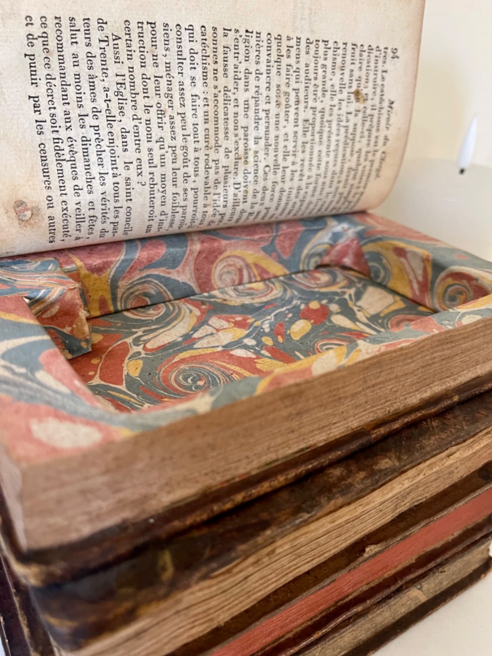An antique novelty box crafted to resemble four French leather-bound book spines with gilt detailing and embossed text. View III