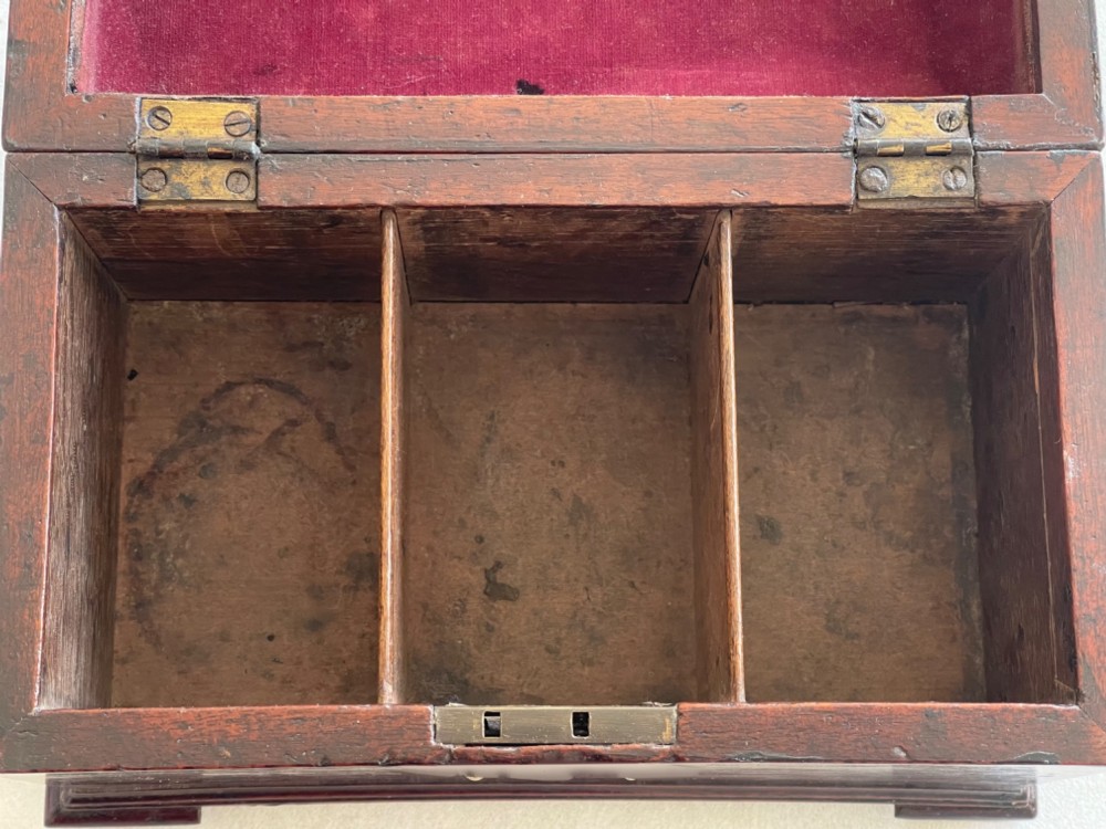 A Georgian dark mahogany tea chest with a stepped lid, brass top handle, ornamental brass escutcheon, and bracket feet. View VIII