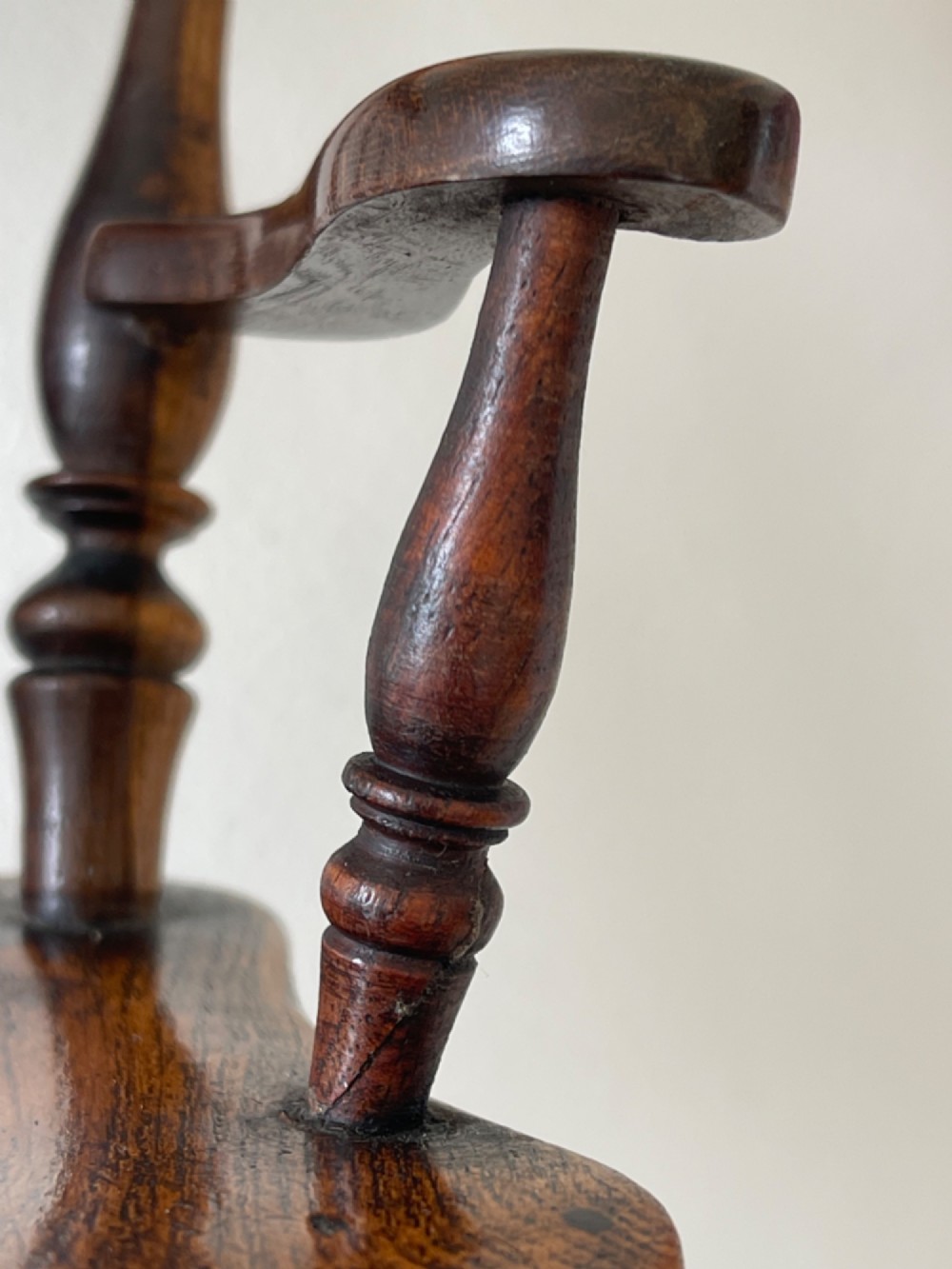 A miniature dark wood Windsor armchair featuring a shaped top rail, turned spindle back, sculpted armrests, and turned legs linked by stretchers. View II