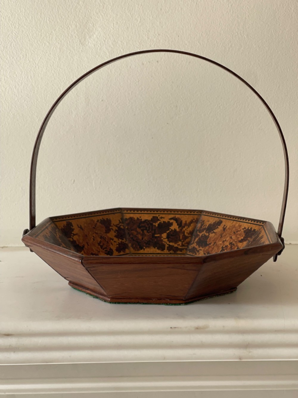 An octagonal Victorian Tunbridge ware wooden sewing basket with a curved overhead handle and floral wood mosaic inlay along the interior panels. View III