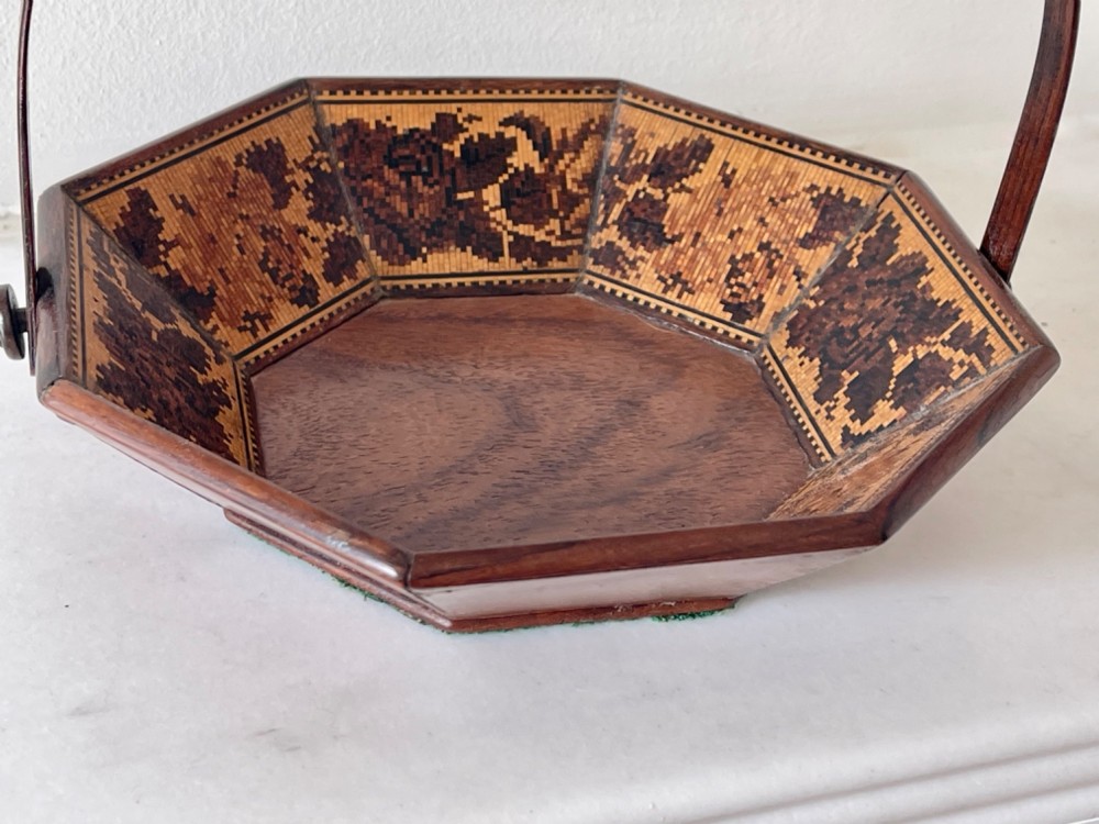 An octagonal Victorian Tunbridge ware wooden sewing basket with a curved overhead handle and floral wood mosaic inlay along the interior panels. View IV
