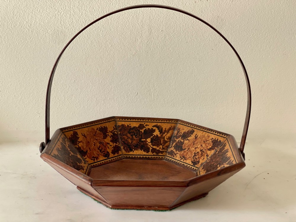 An octagonal Victorian Tunbridge ware wooden sewing basket with a curved overhead handle and floral wood mosaic inlay along the interior panels. View VII