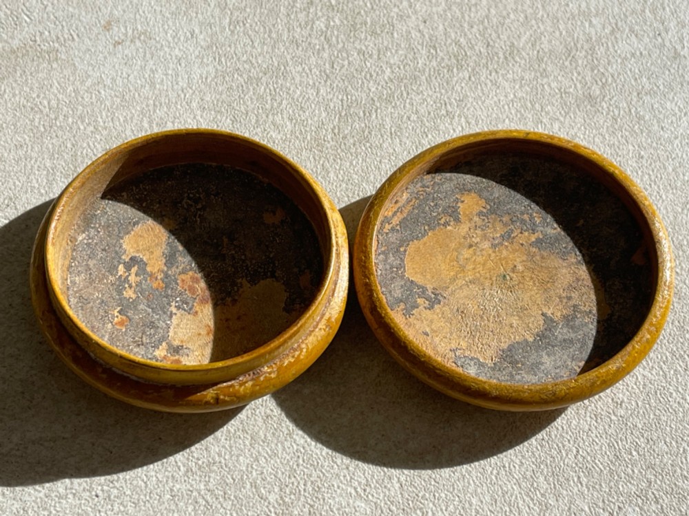 A circular yellow wooden antique Scottish snuff box with a printed love poem on the top lid. View IV