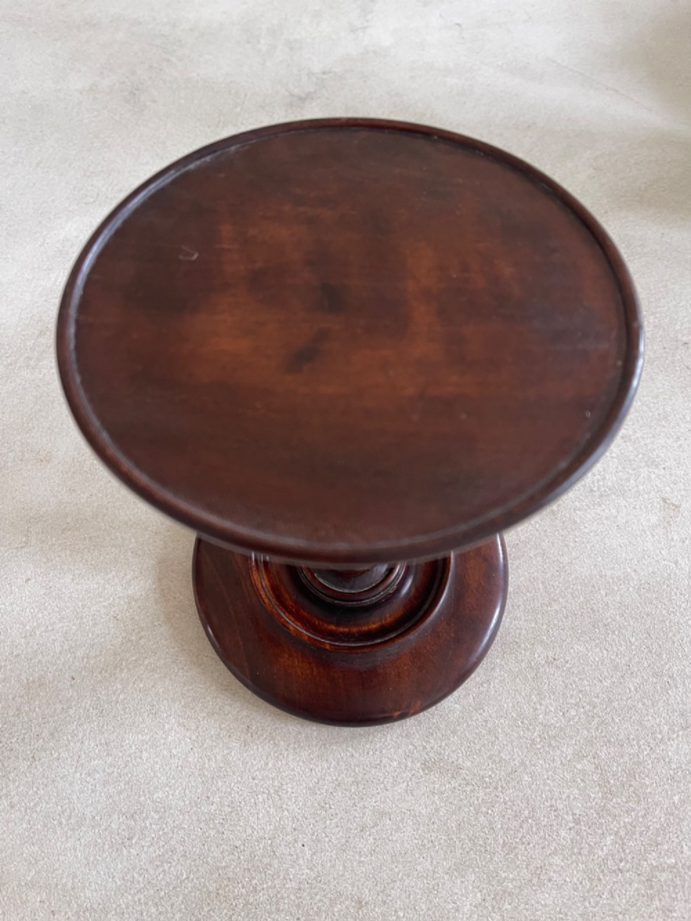 A dark turned mahogany Georgian candle stand featuring a height-adjustment screw mechanism, a dished circular top tray, and a wide circular base. View II