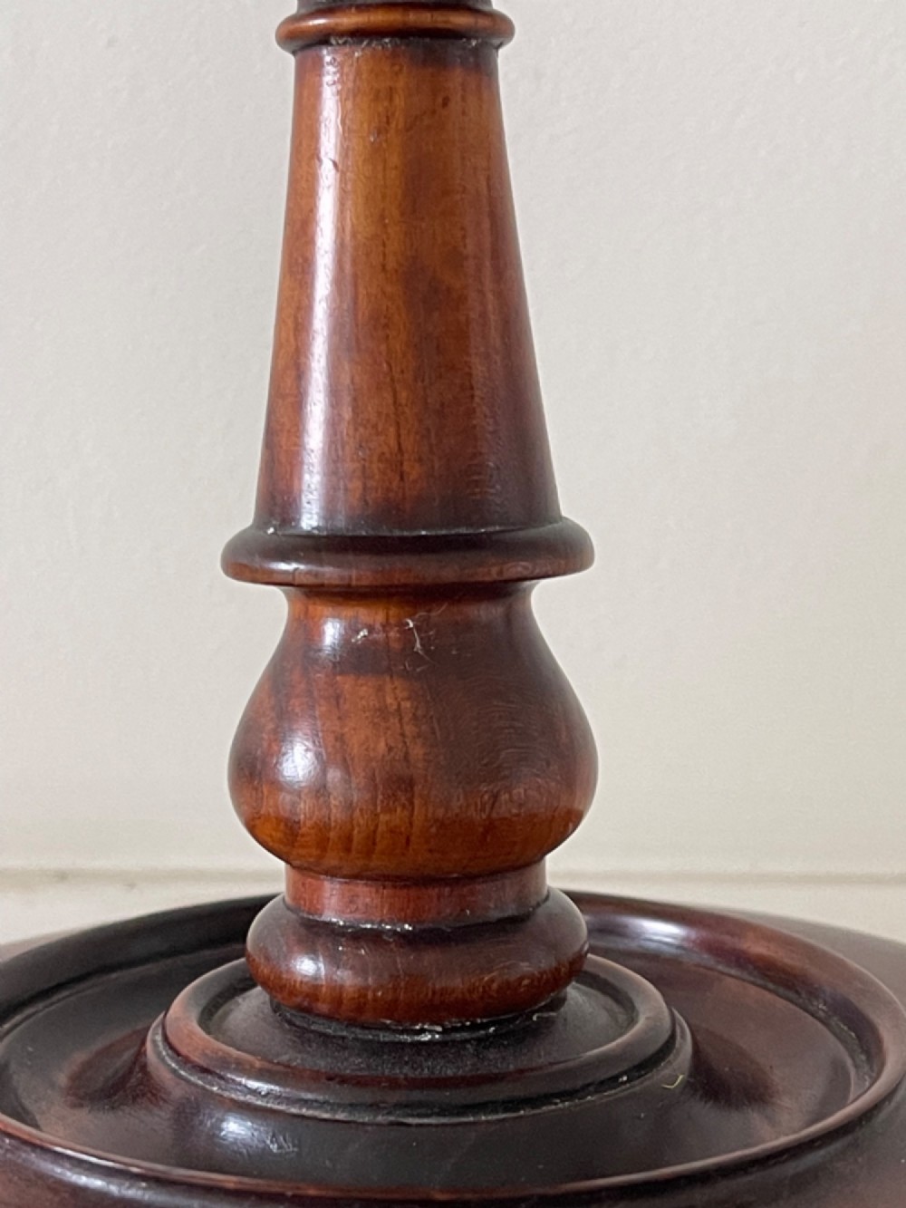 A dark turned mahogany Georgian candle stand featuring a height-adjustment screw mechanism, a dished circular top tray, and a wide circular base. View IV