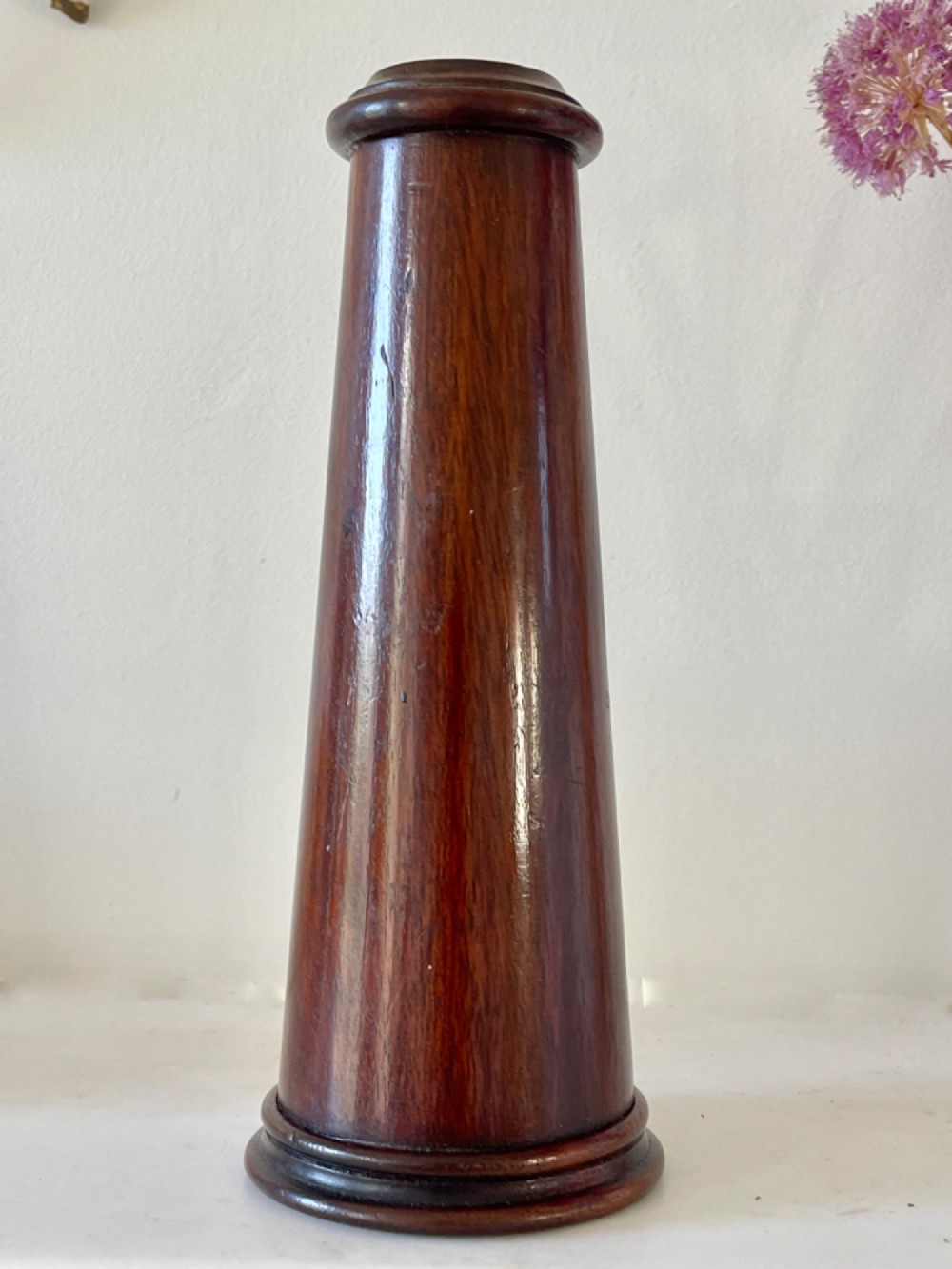 An upright turned dark mahogany wooden kaleidoscope with a tapered conical body and rounded moulded borders. View III