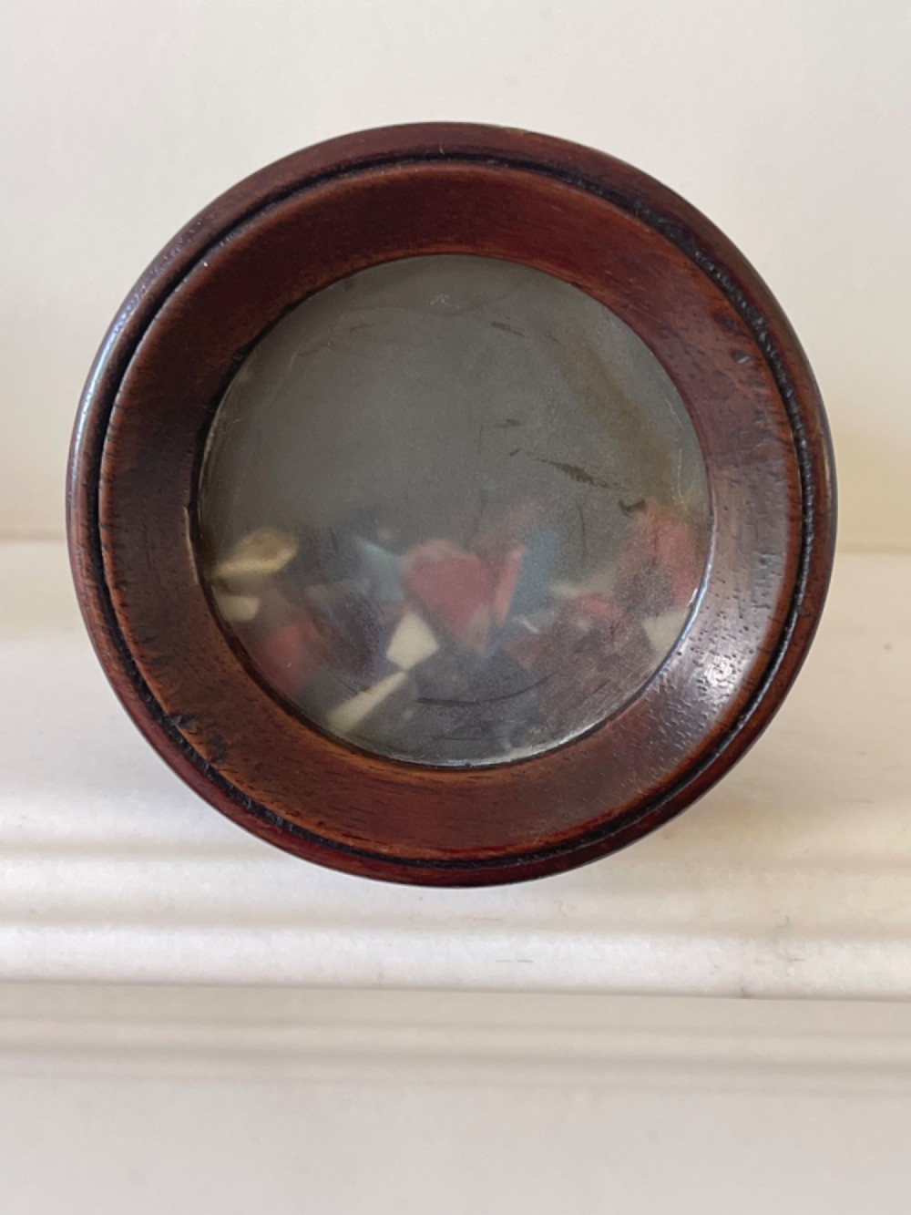 An upright turned dark mahogany wooden kaleidoscope with a tapered conical body and rounded moulded borders. View IV