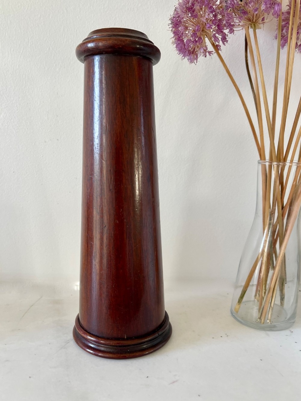 An upright turned dark mahogany wooden kaleidoscope with a tapered conical body and rounded moulded borders. View V