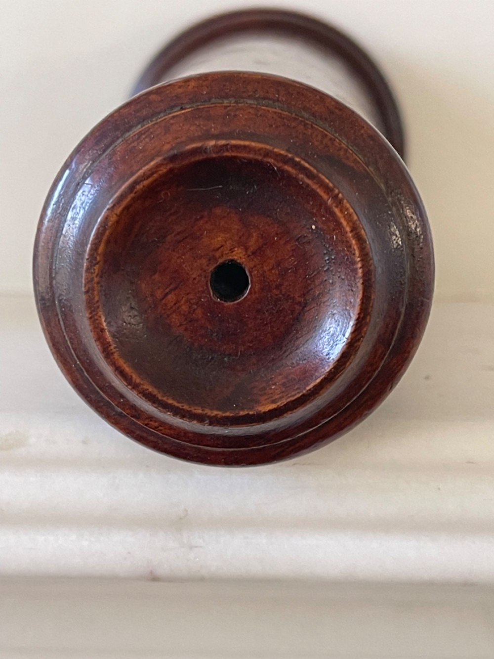 An upright turned dark mahogany wooden kaleidoscope with a tapered conical body and rounded moulded borders. View VI