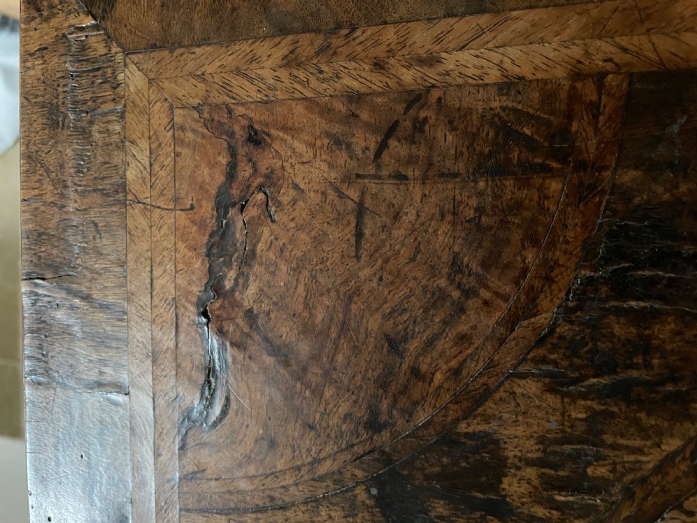 A late 17th-century walnut chest of drawers featuring brass teardrop handles, keyhole escutcheons, crossbanded veneer drawer fronts, and turned bun feet. View XII