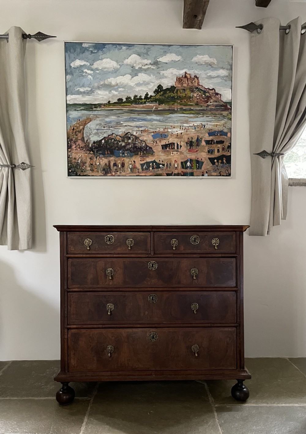A late 17th-century walnut chest of drawers featuring brass teardrop handles, keyhole escutcheons, crossbanded veneer drawer fronts, and turned bun feet. View XVI
