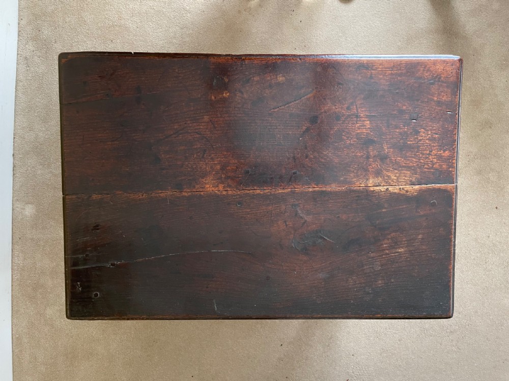 A 17th-century dark oak rent table featuring two frieze drawers with decorative brass handles, supported on turned legs with a rectangular perimeter stretcher. View VII