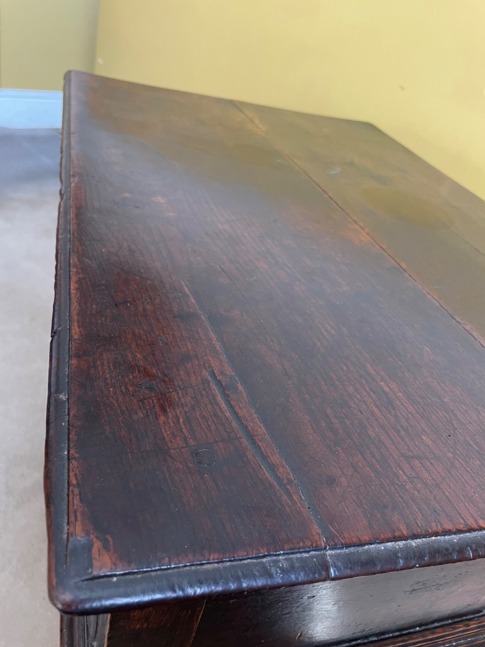A 17th-century dark oak rent table featuring two frieze drawers with decorative brass handles, supported on turned legs with a rectangular perimeter stretcher. View XII