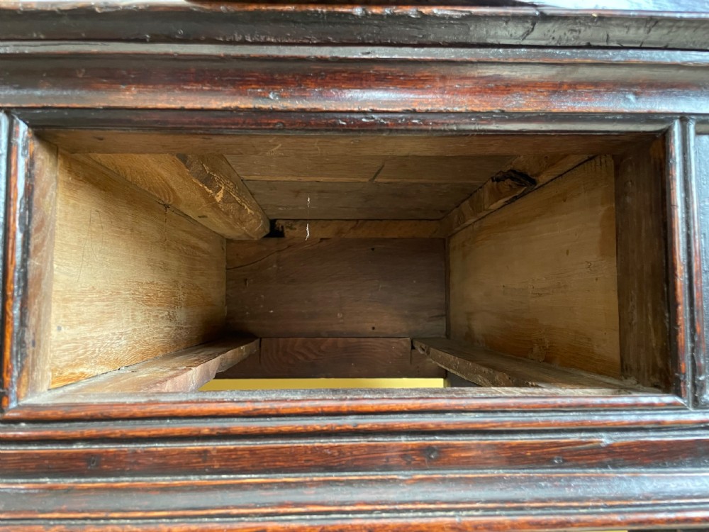 A 17th-century dark oak rent table featuring two frieze drawers with decorative brass handles, supported on turned legs with a rectangular perimeter stretcher. View XIV