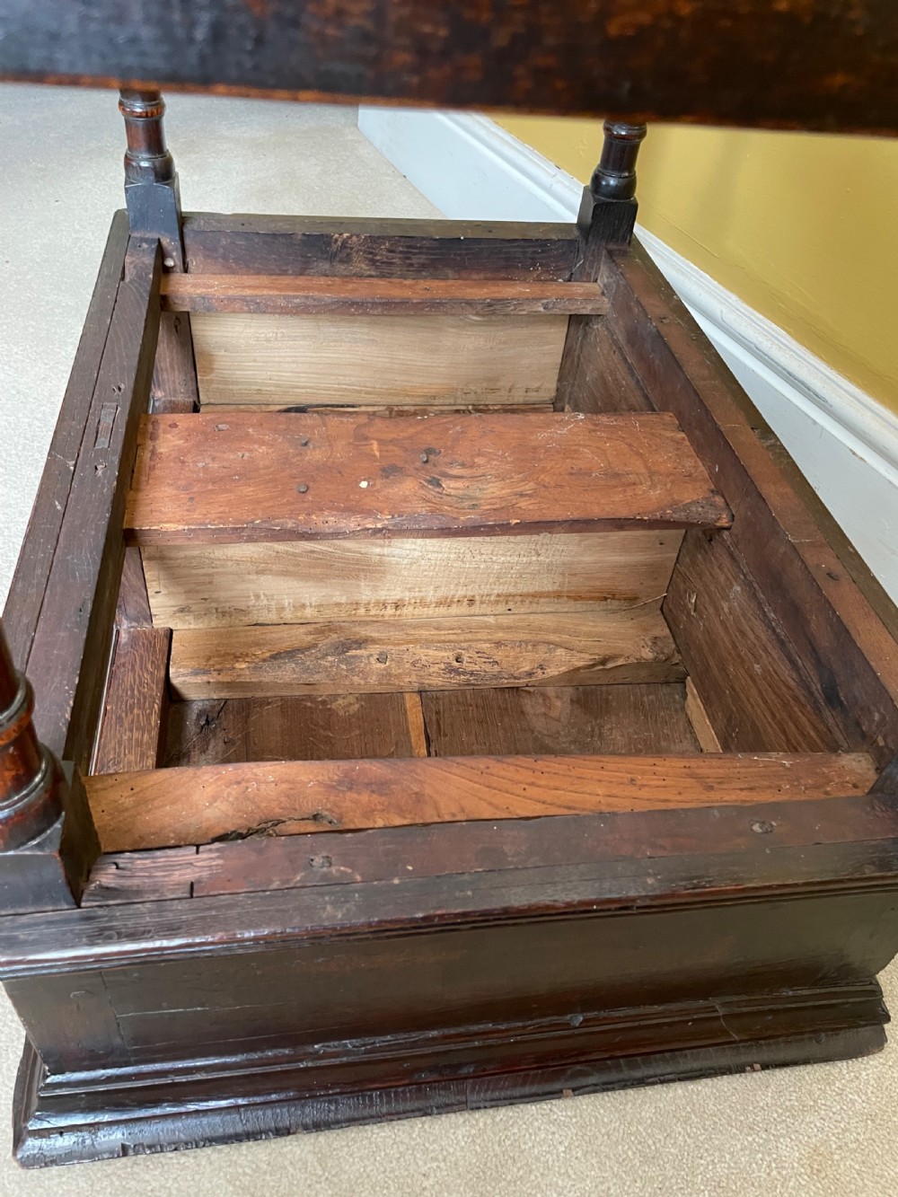 A 17th-century dark oak rent table featuring two frieze drawers with decorative brass handles, supported on turned legs with a rectangular perimeter stretcher. View XV