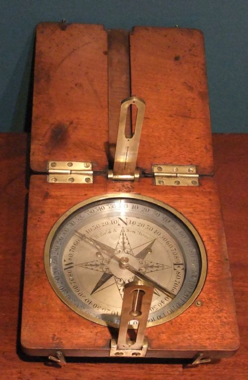fig 1. A circular Georgian brass and silvered compass rose with engraved degree markings housed in a square mahogany timber frame.