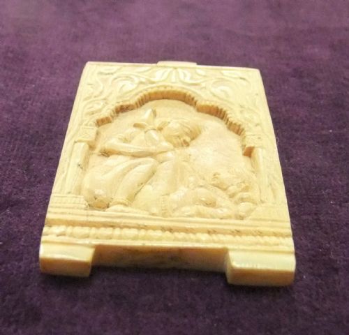fig 1. An 18th-century cream-coloured carved relief panel depicting figures within an architectural arch.