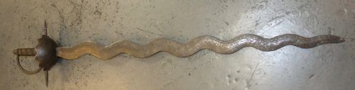 fig 1. A 17th-century steel cup-hilt sword featuring a long wavy flamberge blade and a rounded metal hand guard.