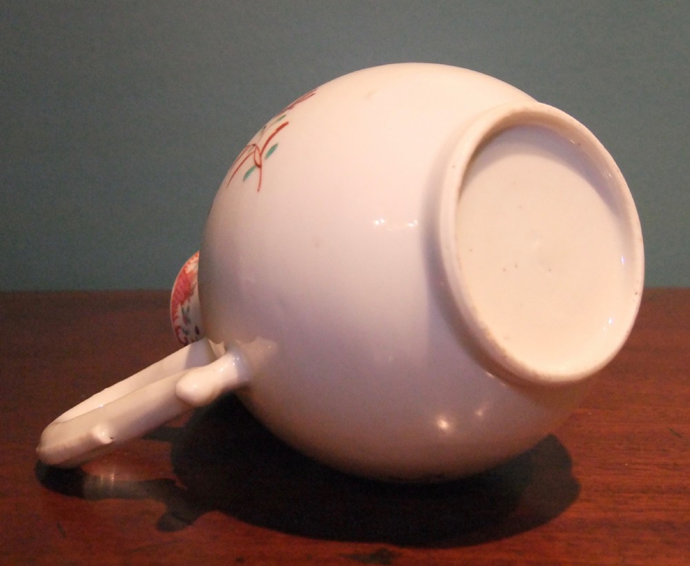 An 18th-century Chinese famille rose porcelain cream jug featuring a sparrow-beak spout and painted floral sprigs on a white ground. View VII