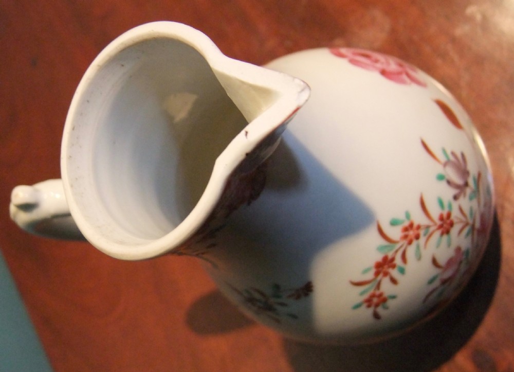 An 18th-century Chinese famille rose porcelain cream jug featuring a sparrow-beak spout and painted floral sprigs on a white ground. View VIII