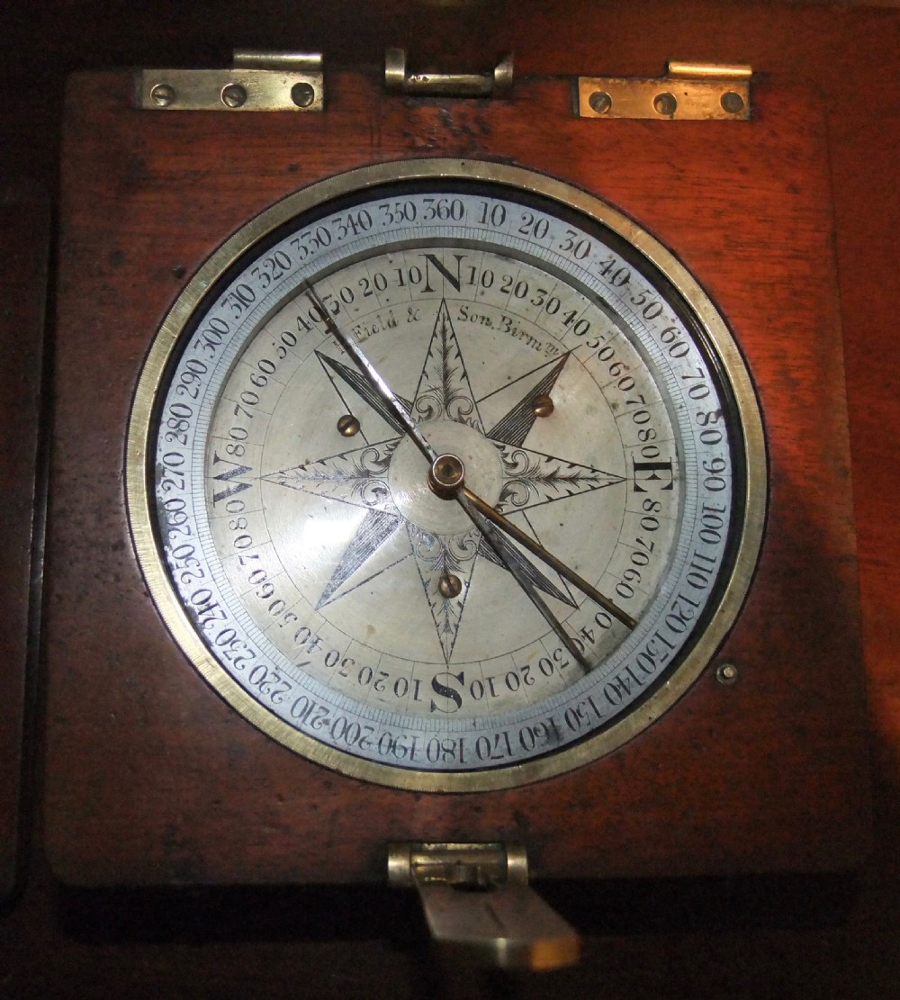 A circular Georgian brass and silvered compass rose with engraved degree markings housed in a square mahogany timber frame. View IV