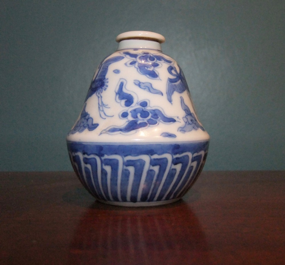 A small bell-shaped Chinese blue and white porcelain lidded bottle decorated with hand-painted flying cranes and cloud motifs. View V