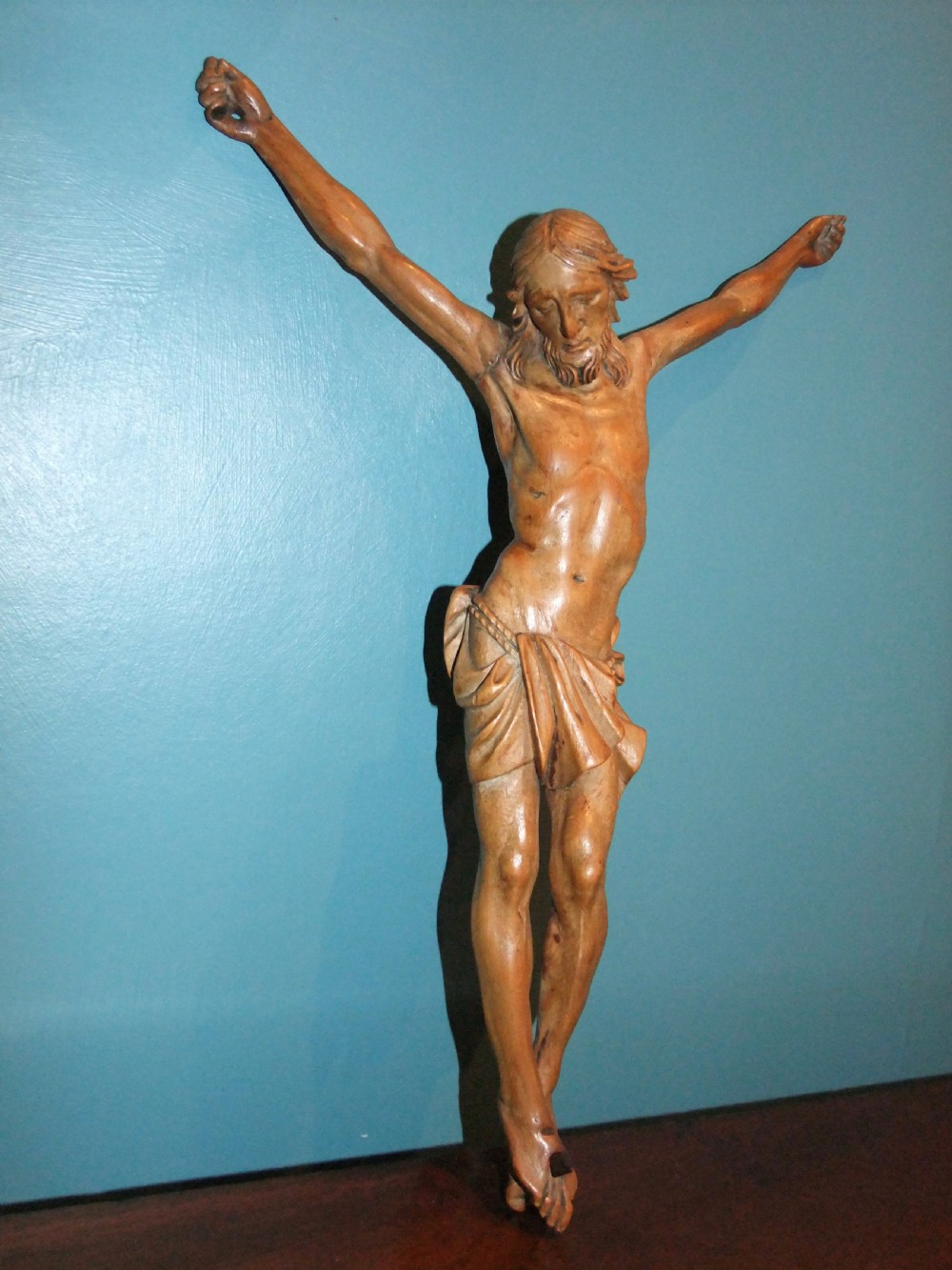 An 18th-century carved fruitwood figure of Corpus Christi showing anatomical detail and draped loincloth against a plain background. View II