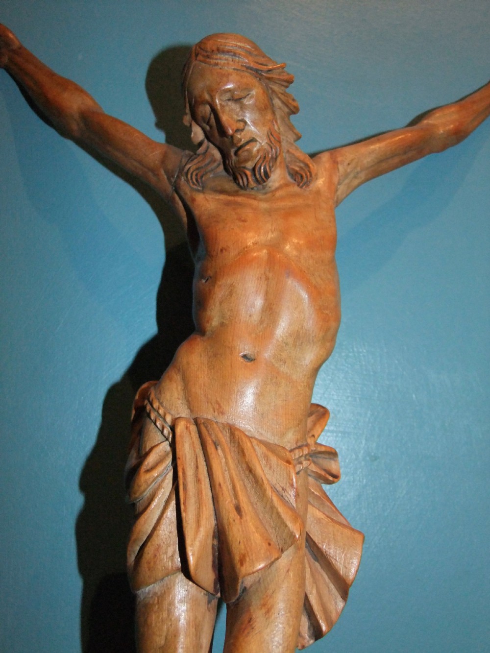 An 18th-century carved fruitwood figure of Corpus Christi showing anatomical detail and draped loincloth against a plain background. View VI