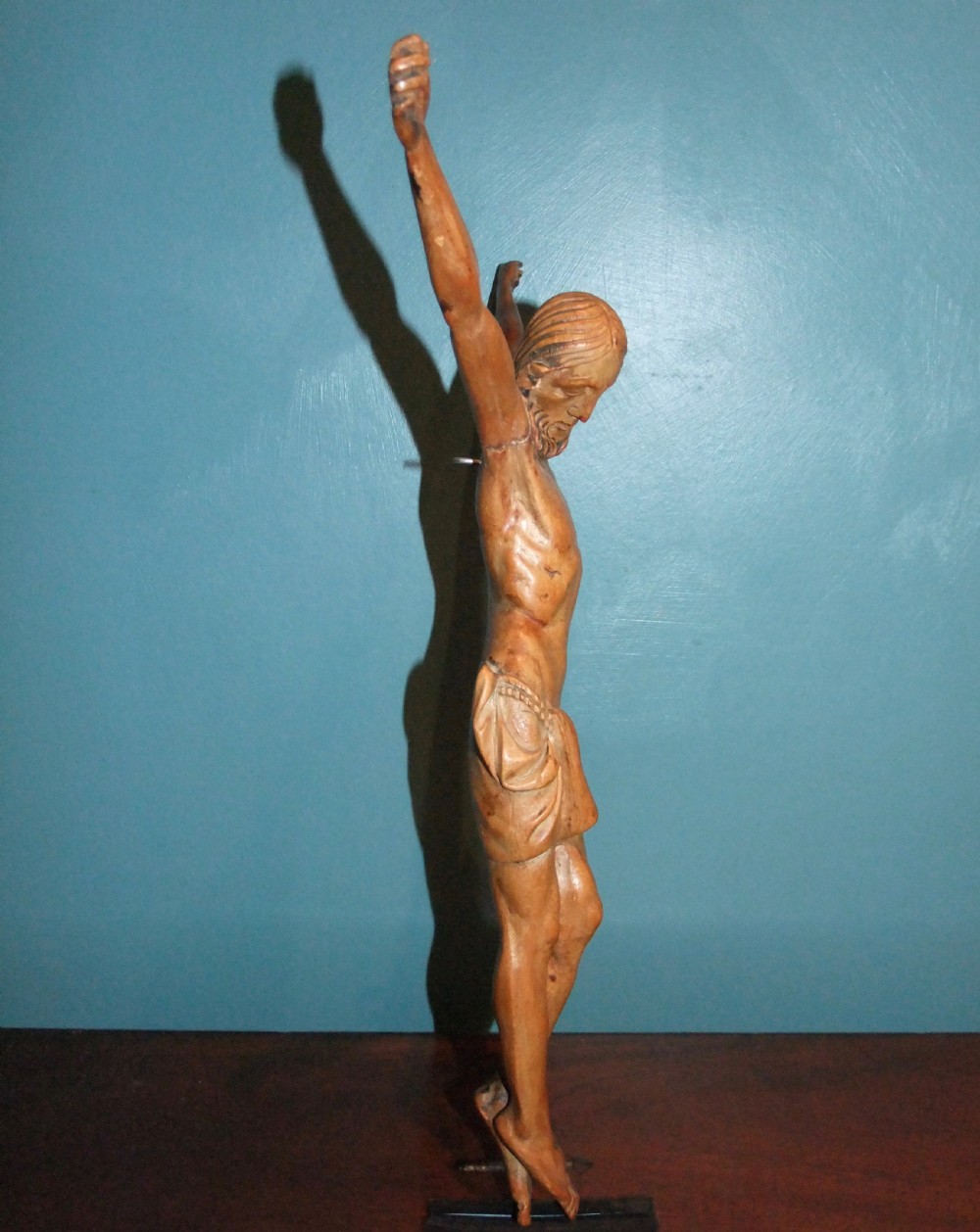An 18th-century carved fruitwood figure of Corpus Christi showing anatomical detail and draped loincloth against a plain background. View XI