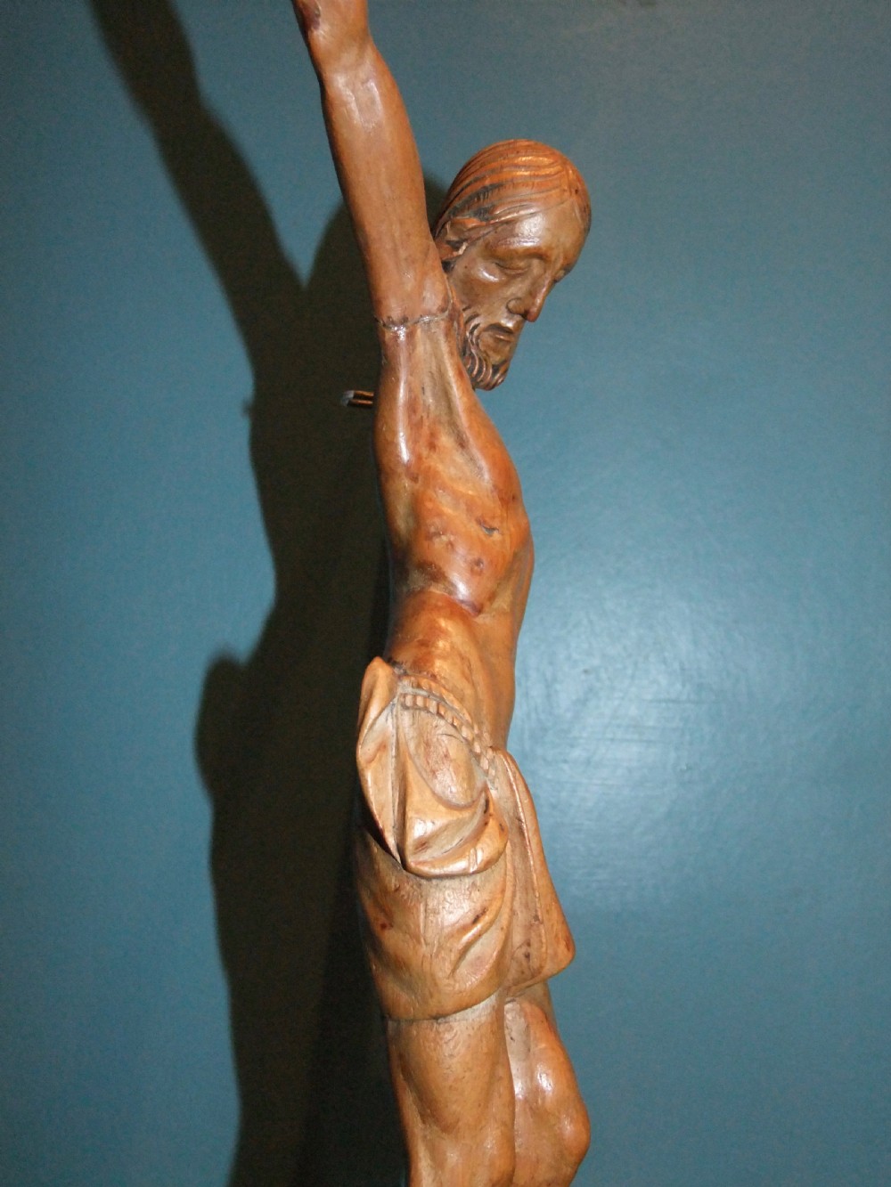 An 18th-century carved fruitwood figure of Corpus Christi showing anatomical detail and draped loincloth against a plain background. View XII