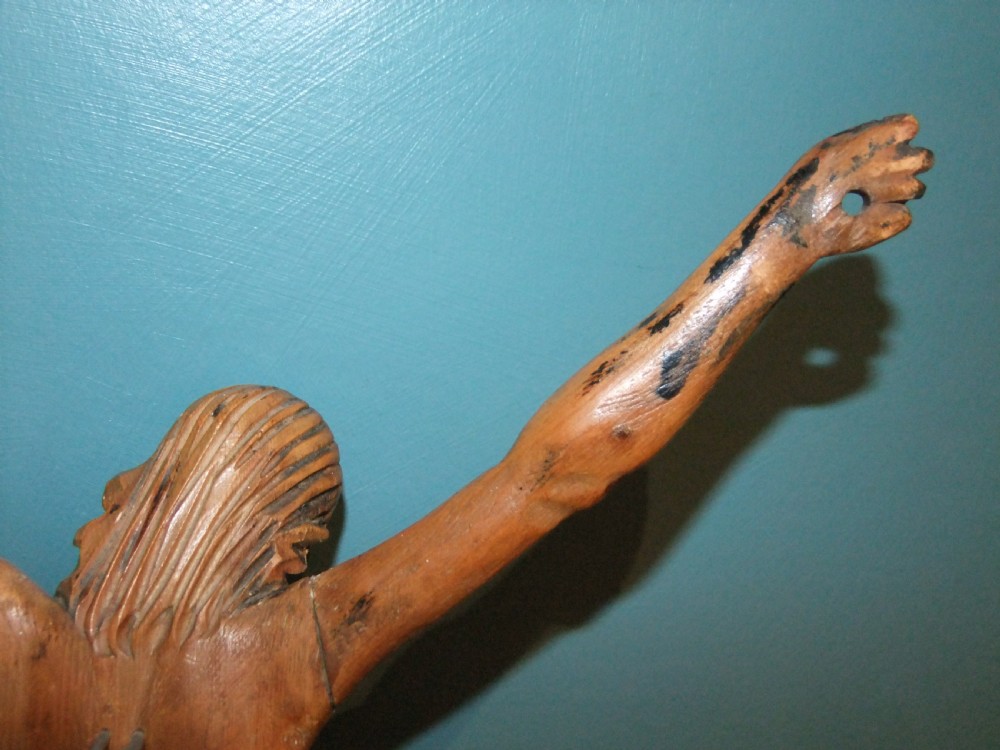 An 18th-century carved fruitwood figure of Corpus Christi showing anatomical detail and draped loincloth against a plain background. View XV