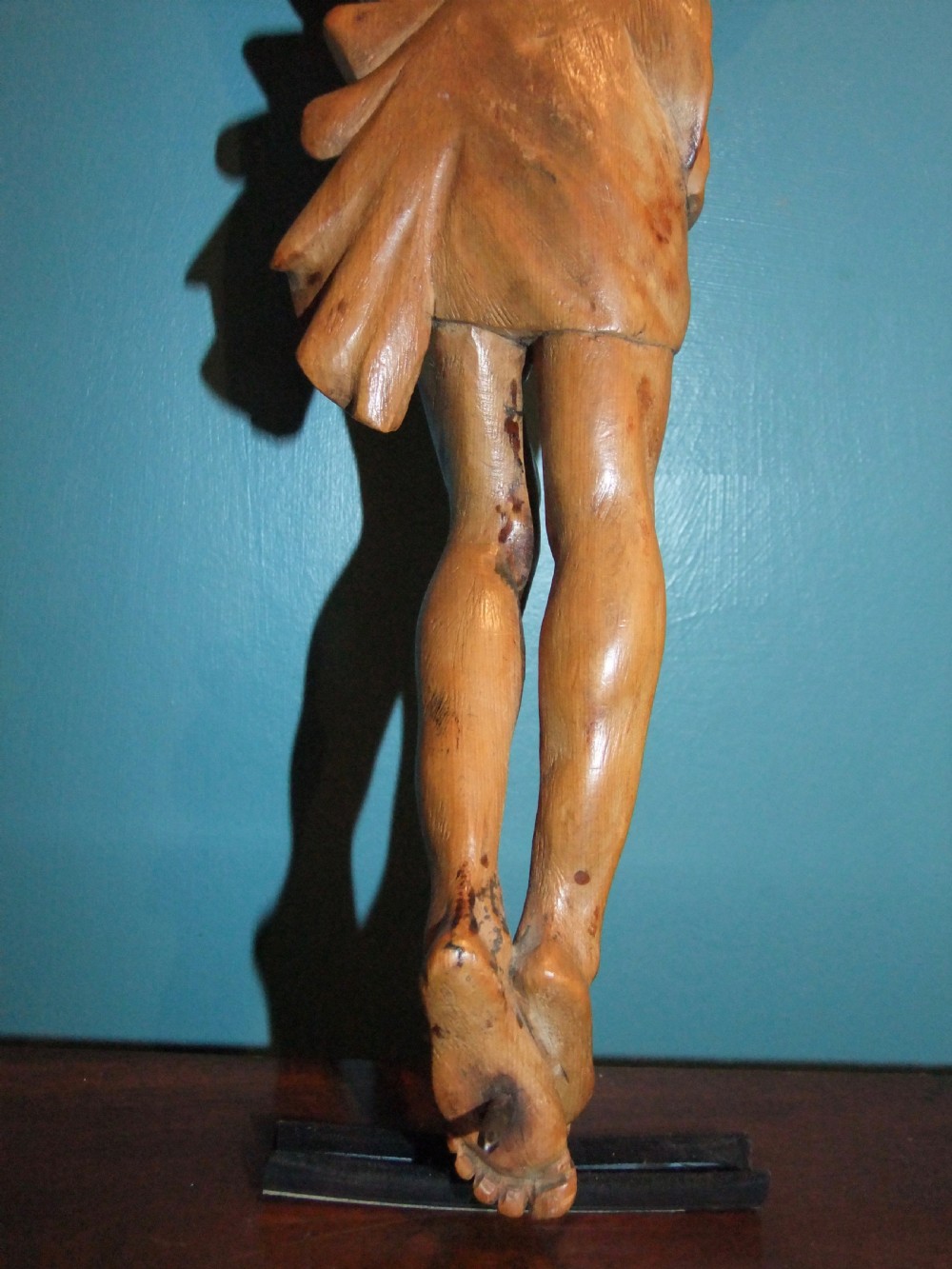 An 18th-century carved fruitwood figure of Corpus Christi showing anatomical detail and draped loincloth against a plain background. View XVII