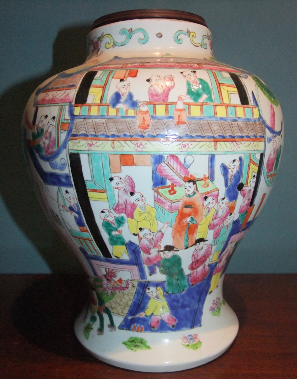 A 19th-century Chinese famille rose porcelain vase painted with polychrome figures and architectural scenes against a white background.