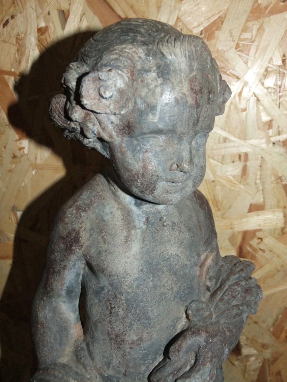 A pair of eighteenth-century Georgian cast lead garden statues depicting standing putti draped in classical fabric. View IV