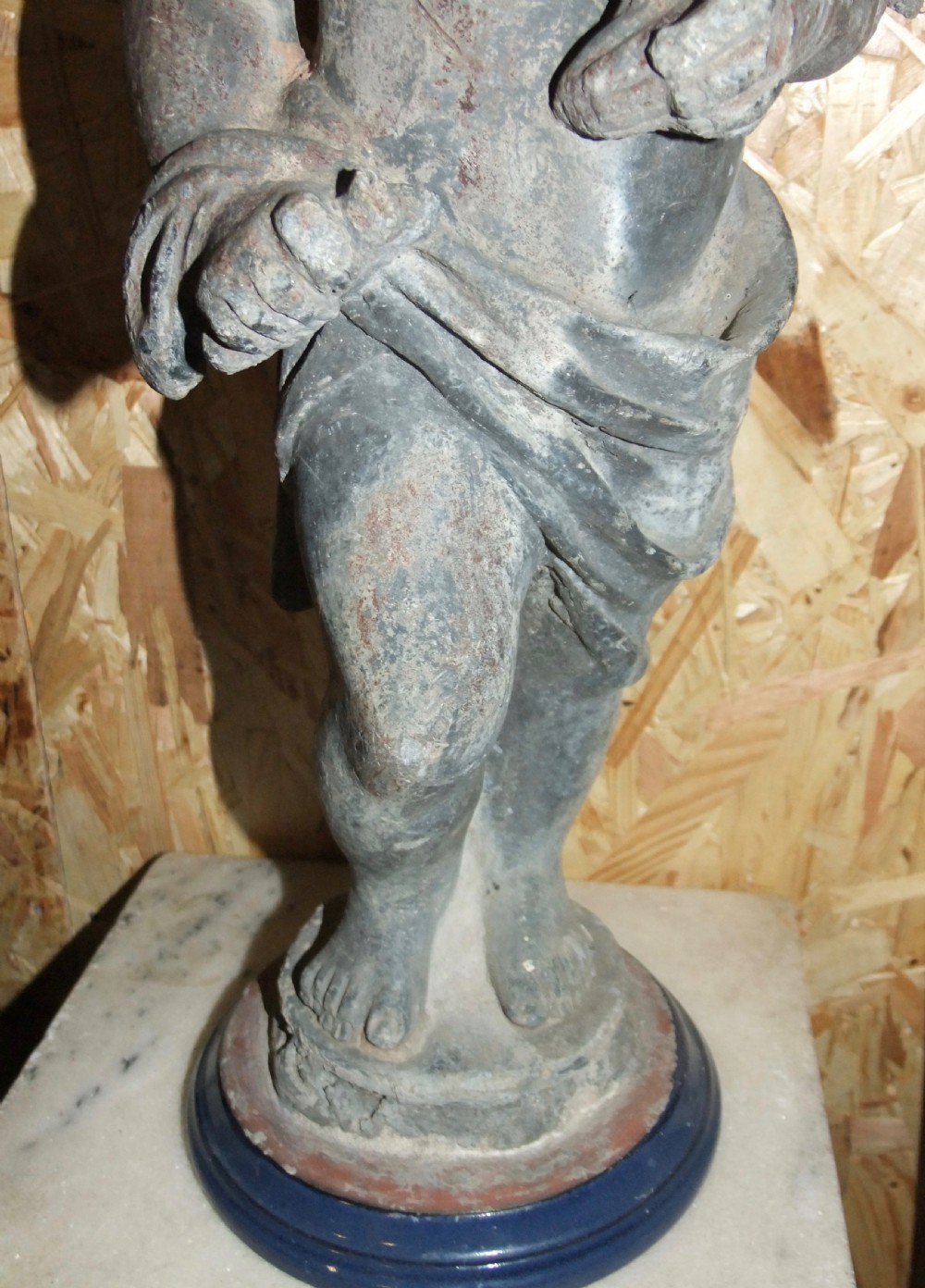 A pair of eighteenth-century Georgian cast lead garden statues depicting standing putti draped in classical fabric. View V