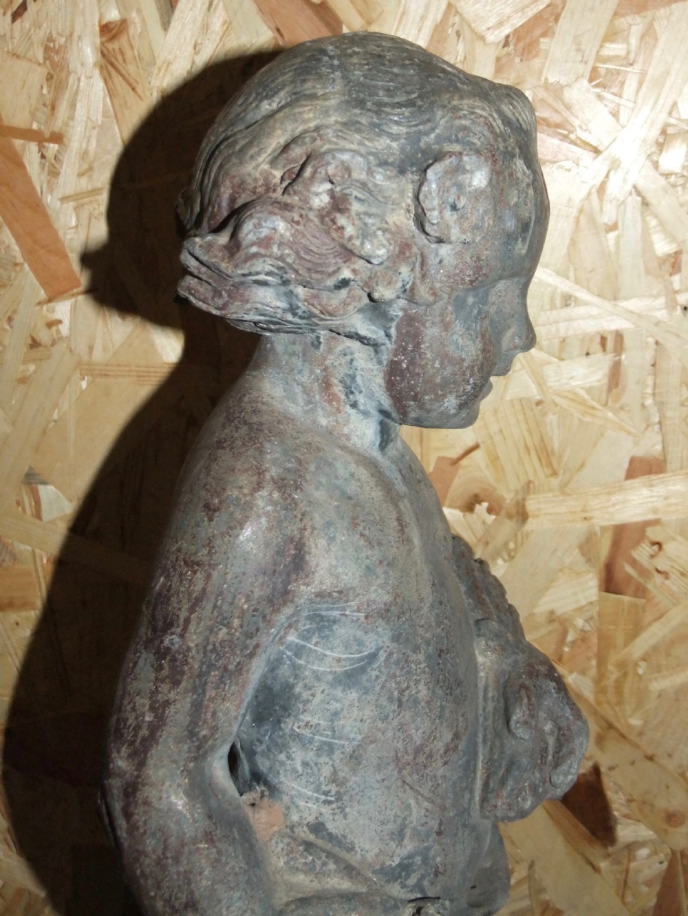 A pair of eighteenth-century Georgian cast lead garden statues depicting standing putti draped in classical fabric. View VII