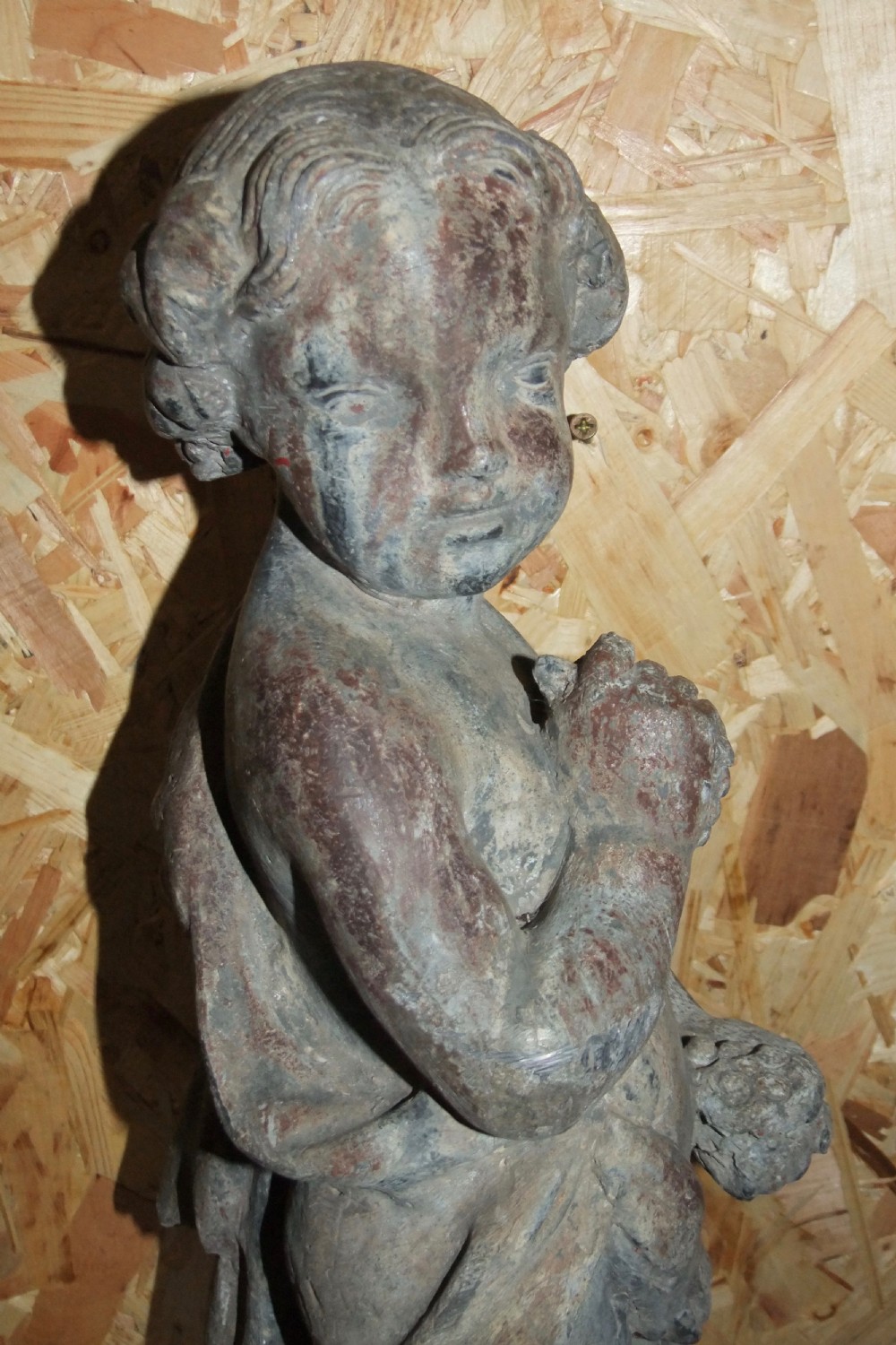 A pair of eighteenth-century Georgian cast lead garden statues depicting standing putti draped in classical fabric. View XVIII