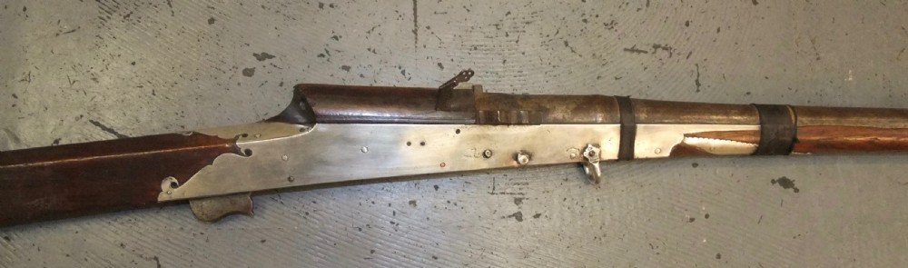 An early 18th-century Indian Toradar matchlock musket with an elongated dark wood stock, a long steel barrel, and metal lock plates. View III