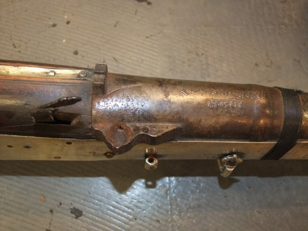 An early 18th-century Indian Toradar matchlock musket with an elongated dark wood stock, a long steel barrel, and metal lock plates. View VII