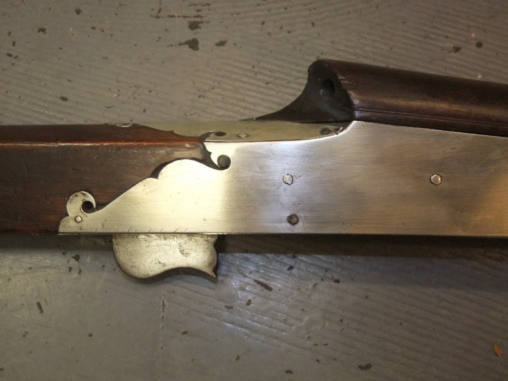An early 18th-century Indian Toradar matchlock musket with an elongated dark wood stock, a long steel barrel, and metal lock plates. View XIII