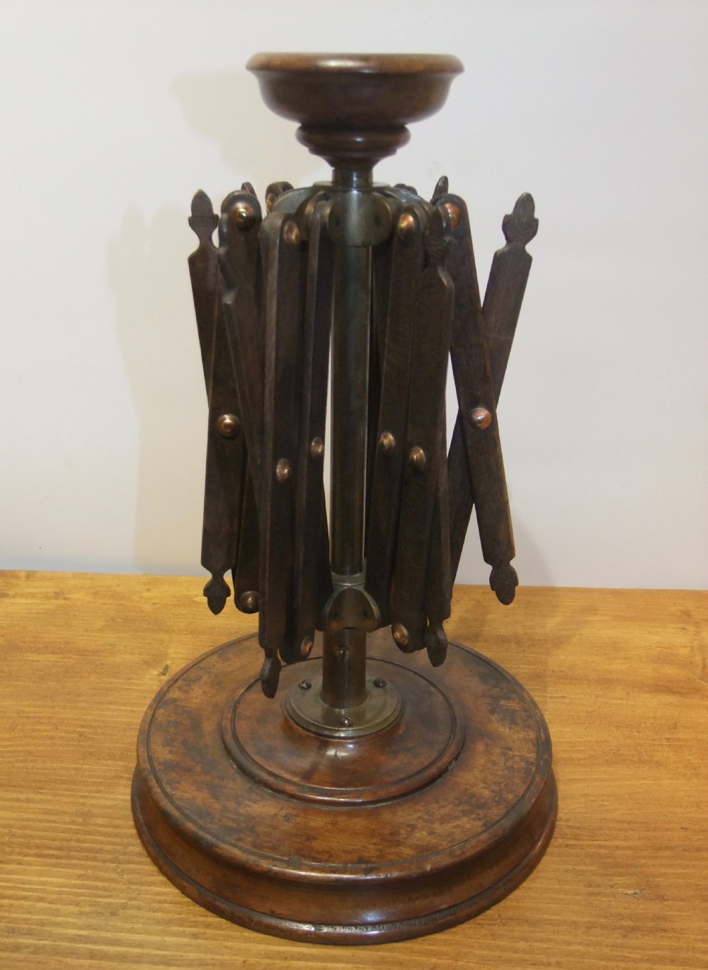 A Victorian dark mahogany table-top wool winder with an adjustable concertina lattice frame mounted on a turned circular base. View III