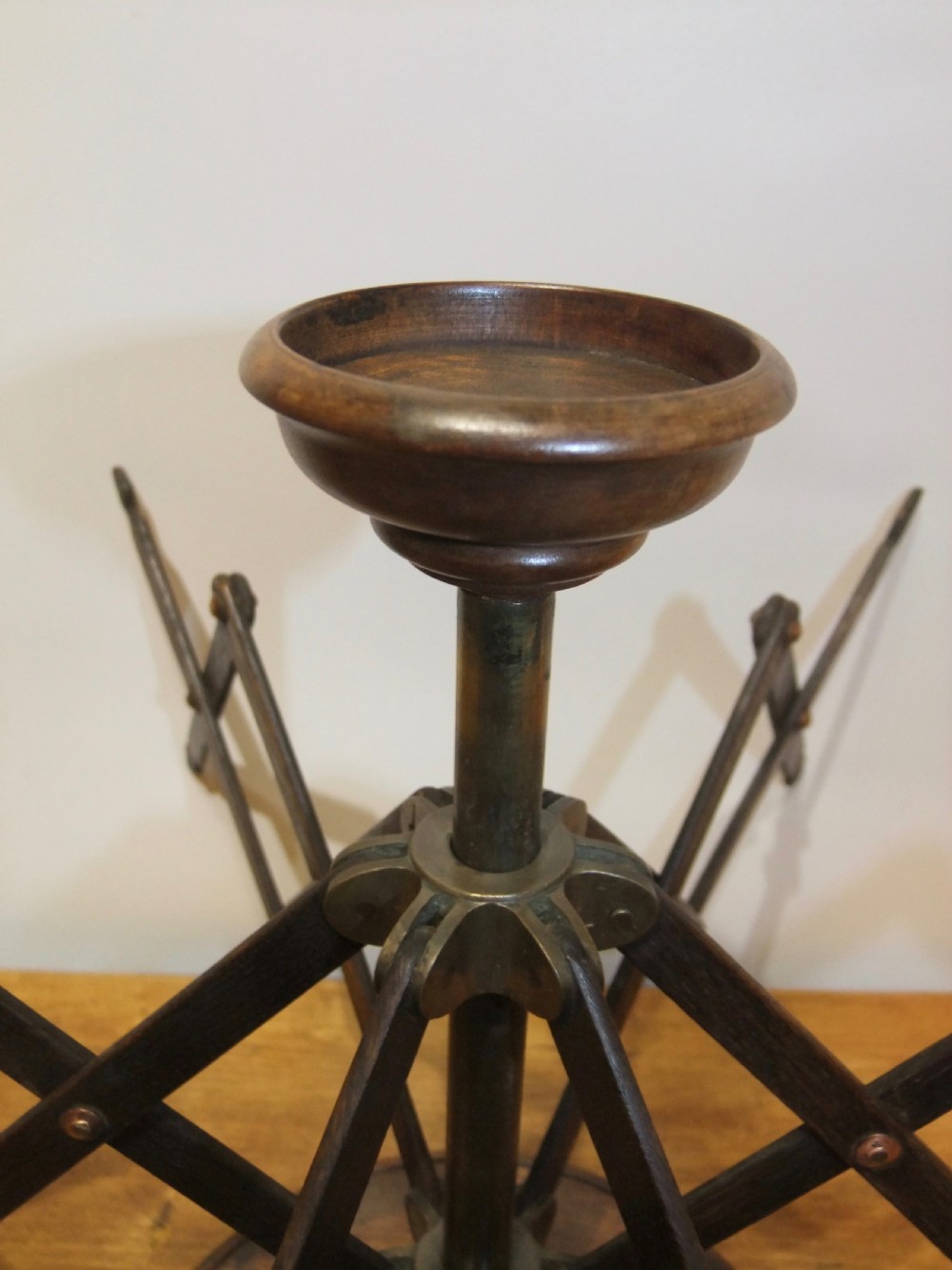 A Victorian dark mahogany table-top wool winder with an adjustable concertina lattice frame mounted on a turned circular base. View IV