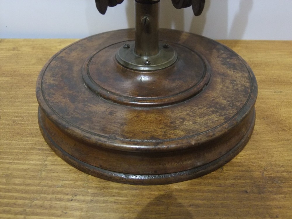 A Victorian dark mahogany table-top wool winder with an adjustable concertina lattice frame mounted on a turned circular base. View VII
