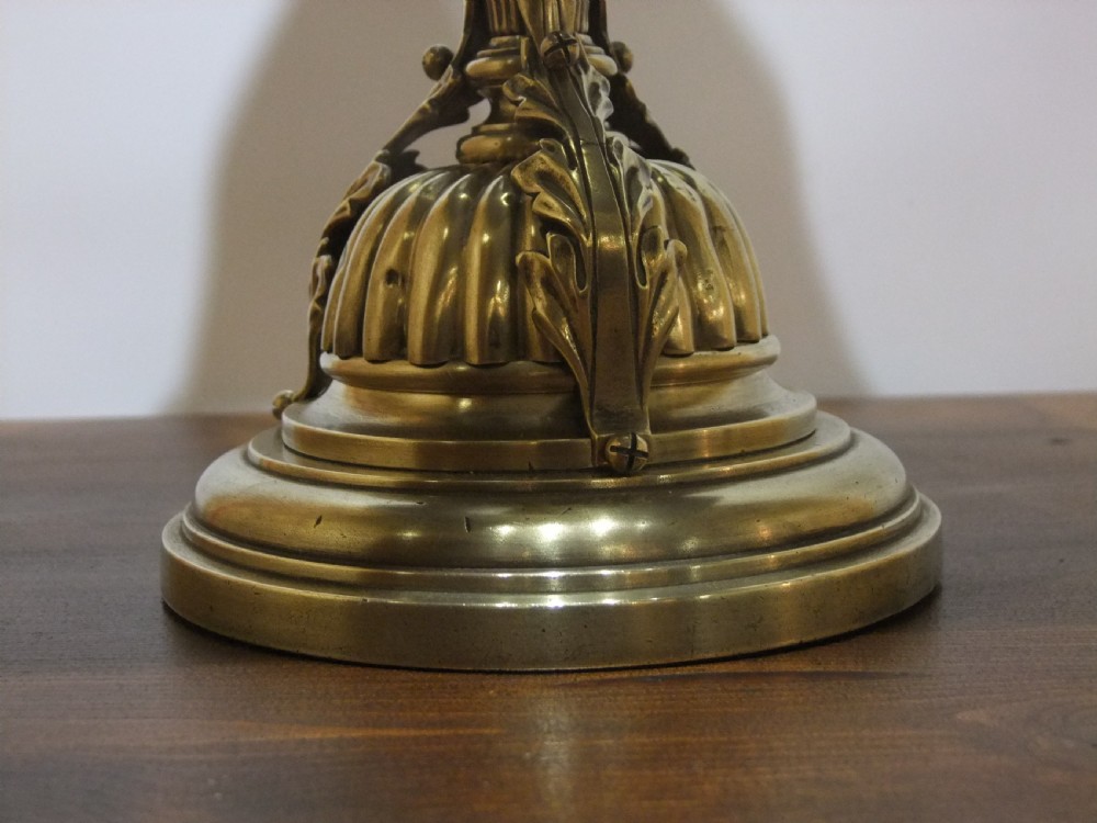 An Edwardian brass table lamp featuring a fluted column base and a black trapezoidal fabric shade. View V