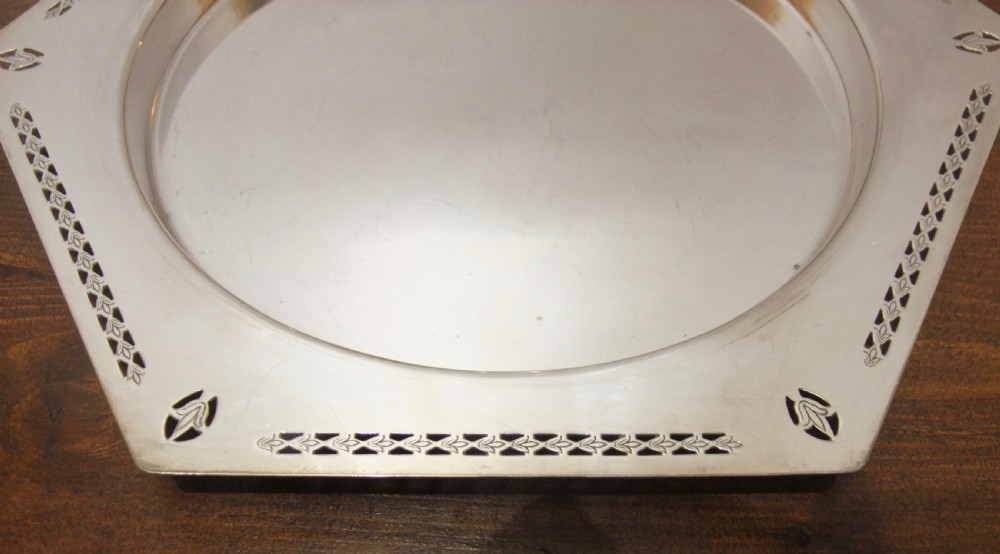 A hexagonal silver-plated dish featuring a circular central recess and pierced geometric borders around the outer rim. View II