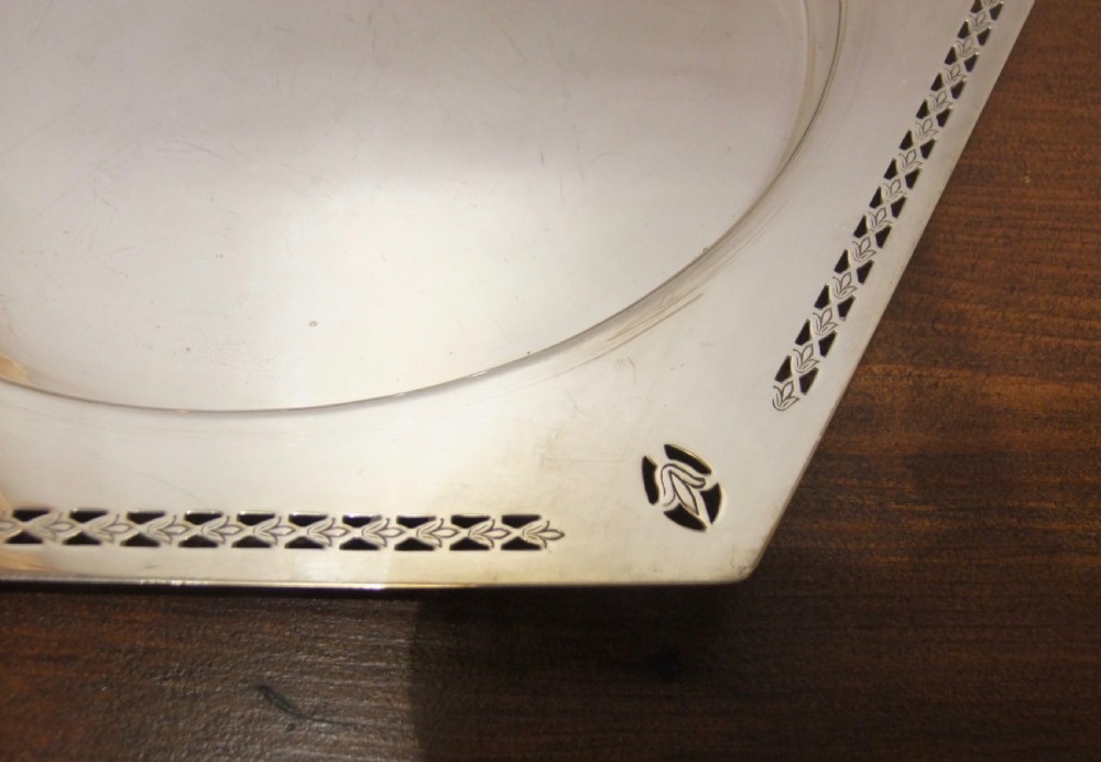 A hexagonal silver-plated dish featuring a circular central recess and pierced geometric borders around the outer rim. View VI