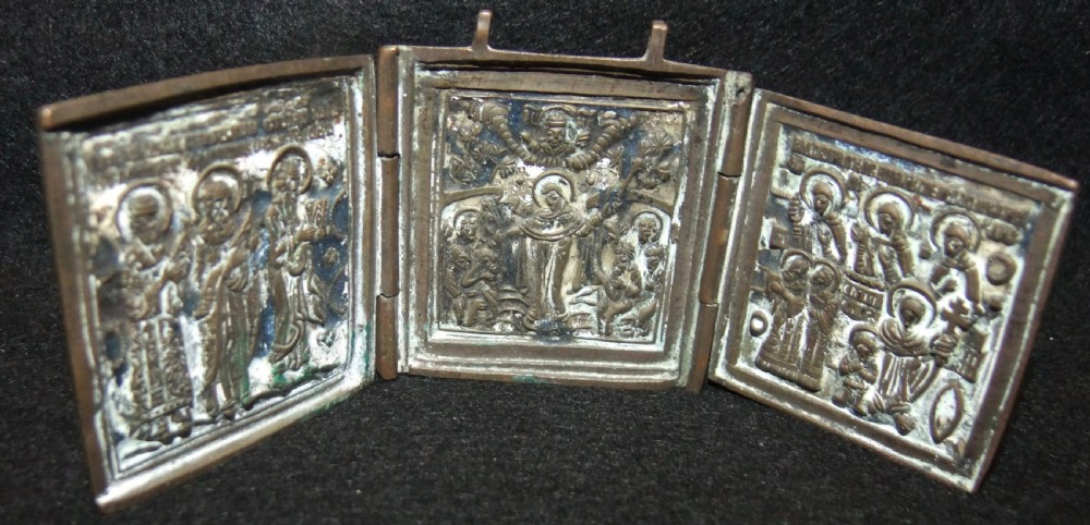 A 19th-century Russian bronze three-panel folding travel triptych icon featuring relief figures and remnants of blue enamel work.