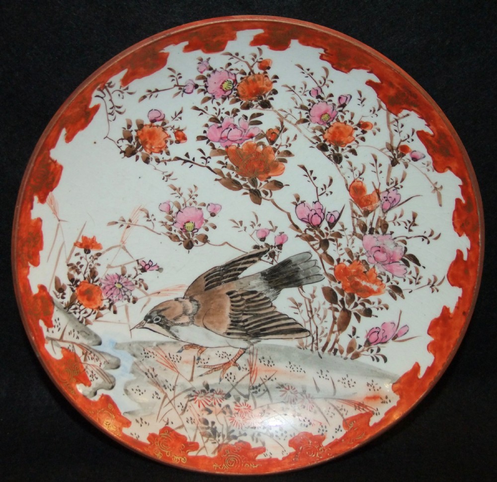 A pair of circular Japanese Kutani porcelain plates decorated with hand-painted sparrows, floral branches, and iron-red gilt borders. View V