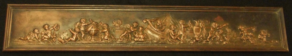 A long horizontal dark bronze relief frieze featuring classical cherubs engaged in allegorical scenes set within a slender rectangular frame.