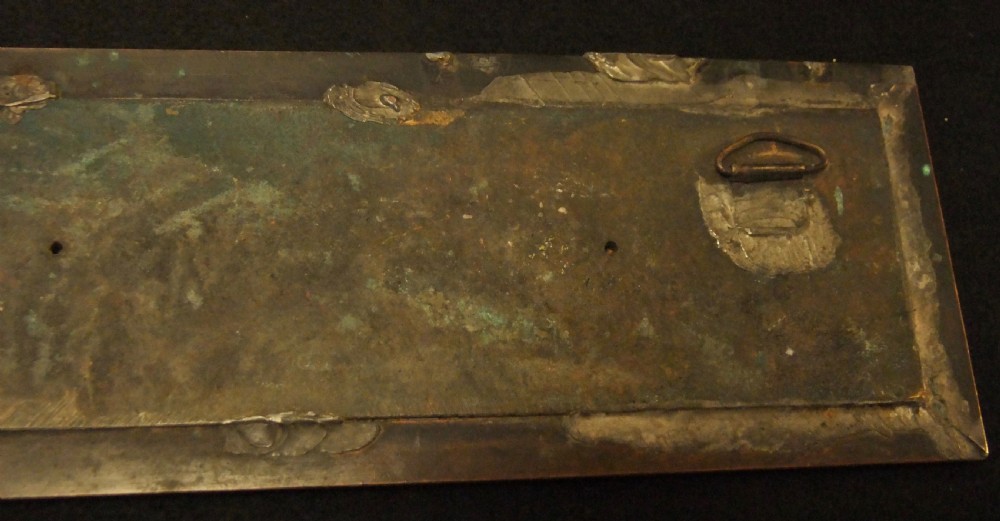 A long horizontal dark bronze relief frieze featuring classical cherubs engaged in allegorical scenes set within a slender rectangular frame. View XVI